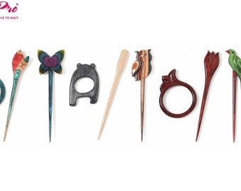May include: A set of nine wooden hair sticks with various designs, including a butterfly, an owl, a bear, a flower, and a bird. The sticks are all made of different types of wood and have a natural finish.