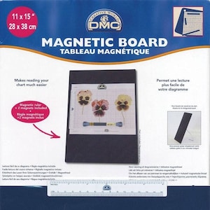 May include: A blue and white magnetic board with a ruler and two magnets included. The board is 28 cm by 38 cm and is designed to make reading cross stitch charts easier. The packaging includes the text "Creative World DMC Magnetic Board Tableau Magnétique".