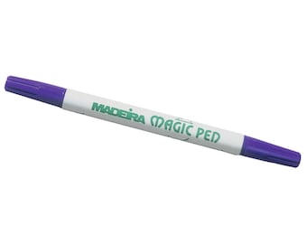May include: A purple and white marking pen with the text "MADEIRA MAGIC PEN" printed in green.