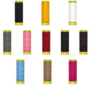 May include: A collection of Gutermann thread spools in various colors, including black, yellow, white, gray, pink, red, and brown. Each spool is labeled with the Gutermann brand and contains 10-11 yards of thread.