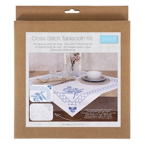 May include: A cross stitch tablecloth kit in a cardboard package. The white tablecloth features a blue floral design and geometric border. The package includes the text "Cross Stitch Tablecloth Kit" and measurements of 31.5 x 31.5 inches.