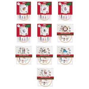 May include: A collection of cross stitch kits featuring holiday-themed designs. Each kit includes a wooden hoop, embroidery floss, and a needle. The designs include a gingerbread man, Santa, a penguin, and more. The kits are packaged in red and white boxes.