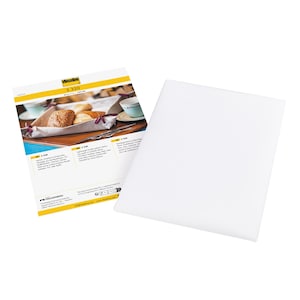 May include: A white rectangular sheet next to a product information sheet. The product sheet has a yellow border and features a photo of baked goods on a tray. Text on the sheet includes "Vlieseline S 320".