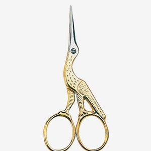 May include: Gold-colored bird-shaped scissors with a pointed tip. The scissors have a detailed design and are perfect for small tasks.