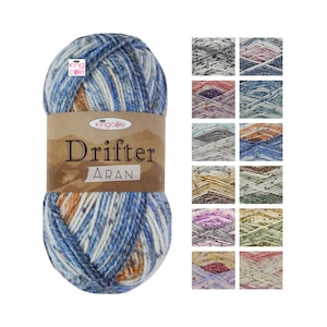 May include: A ball of King Cole Drifter Aran yarn in the colorway "Driftwood". The yarn is a blend of wool and acrylic and has a speckled appearance. The yarn is shown with a variety of other colorways.