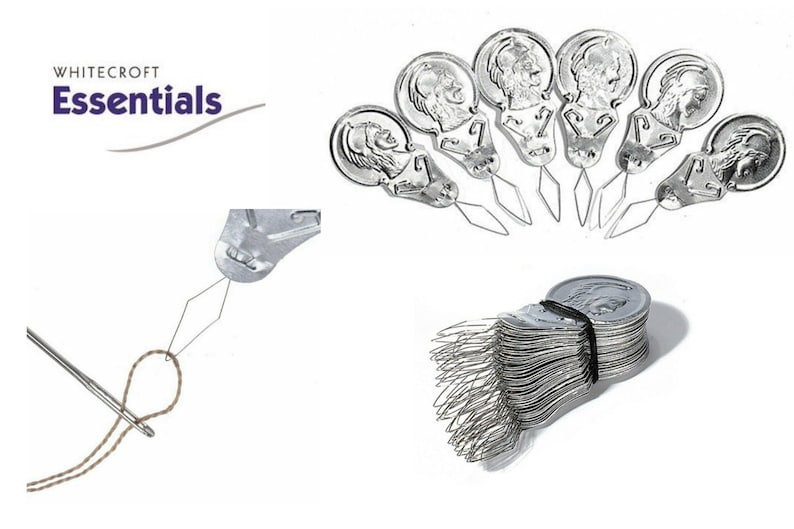 May include: A pack of 50 silver needle threaders with a black rubber band holding them together. The threaders are shaped like a small, round, metal disc with a needle-like point extending from the center. The threaders are designed to help thread needles easily.
