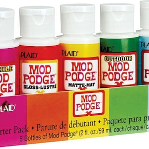 May include: A starter pack of five Mod Podge bottles, each 2 fl oz. The bottles are in a colorful box with the Plaid logo. The bottles include Sparkle, Gloss-Lustre, Matte-Mat, Outdoor, and Paper Mod Podge.