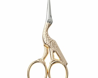 May include: Gold-toned scissors shaped like a bird with a silver blade. The scissors have a detailed design and are perfect for small tasks.