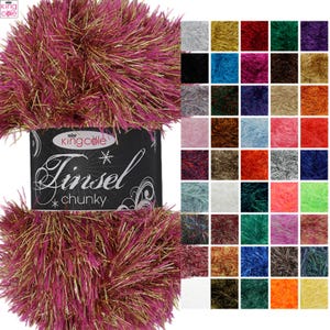 May include: A skein of King Cole Tinsel Chunky yarn in a magenta and gold metallic blend, featuring a black label with white text. To the right, a grid displays forty-eight small square swatches of the same yarn in various solid and mixed colors.