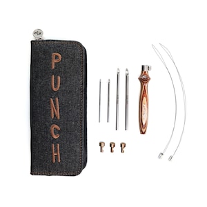 May include: A set of leather punch tools in a black denim zippered pouch. The set includes five needles, a wooden handled punch tool, and two loops. The pouch has the word "PUNCH" embroidered on it in brown thread.