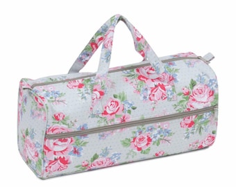 May include: A gray and white floral print fabric tote bag with two zippered compartments. The bag has a single top handle.