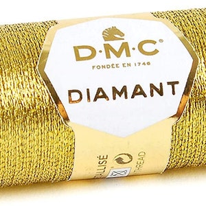May include: A spool of gold metallic thread labeled "DMC Diamant" with a horse logo and the text "Fond&eacute;e en 1746".
