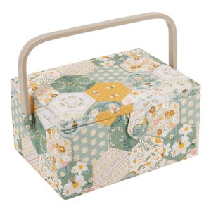 May include: A fabric sewing box with a beige handle. The box is covered in a patchwork design of hexagonal shapes in shades of green, yellow, and white, with floral and bee patterns. A button closure secures the lid.