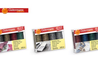 May include: Three packs of Gütermann 100% Creativ metallic effect thread, each pack containing four spools of thread in different colors. Each pack is labeled "Value Pack!" and includes 100 meters of thread.