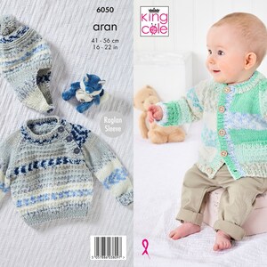 May include: A knitting pattern for a baby cardigan and hat. The pattern is for a size 16-22 inches (41-56 cm) and features a raglan sleeve design. The cardigan is shown in a light blue and white colour scheme with a snowflake pattern. The hat is shown in a light blue and white colour scheme with a pom-pom on top.