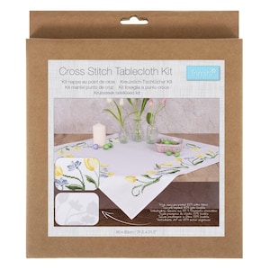 May include: A cross stitch tablecloth kit in a brown cardboard box. The kit includes a white tablecloth with a floral design, a candle, and small vases with flowers. The tablecloth measures 31.5 x 31.5 inches.