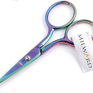 May include: Rainbow-colored stainless steel scissors with a pointed tip. The scissors have a small label attached to them that says "Milward" and "F18 9011".