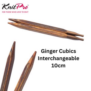 May include: KnitPro Ginger Cubics interchangeable knitting needles measuring 10cm. The needles feature a dark brown wood grain pattern with a square cross-section and smooth, tapered tips. The base of each needle has a metallic brown connector.