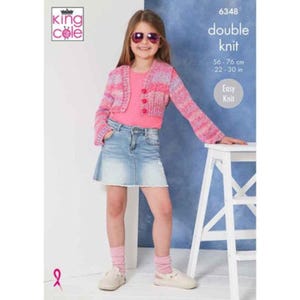 May include: A child wearing a pink and purple double knit cardigan with three buttons, paired with a pink top and denim skirt. The image also shows the text "double knit" and "Easy Knit". The cardigan measures 22-30 inches.