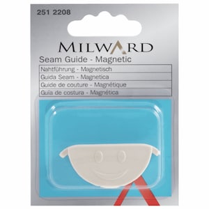 May include: A white plastic seam guide with a magnetic backing. The guide is shaped like a smile and is packaged in a clear plastic blister pack with a blue background. The packaging also includes the text "MILWARD Seam Guide - Magnetic" and the product number "251 2208".
