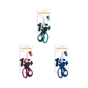 May include: Three packages of Fiskars Teen Scissors. The scissors are black with a blue, pink, and teal handle. The packaging features the Fiskars logo and the text "Teen Scissors".