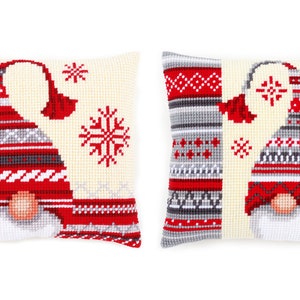 May include: Two white pillow covers with a red and gray gnome design. The gnome is wearing a red and white hat with a gray brim. The pillow covers have a snowflake design and a red and gray patterned border.