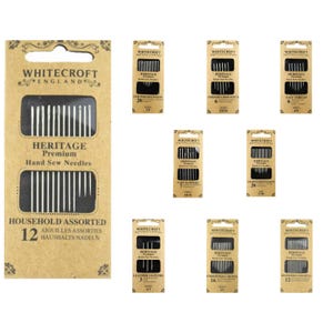 May include: A selection of Whitecroft England Heritage Premium hand sew needles. The main pack is tan and reads "Household Assorted 12". Other packs include "Quilters Between", "Tapestry/Cross-Stitch", "Easy Thread", "Tarn Darners", "Sharps/Needlemakers", "Leather Glovers", and "Embroiderers Crewel".