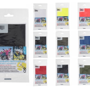 May include: A pack of 10x16 cm adhesive waterproof and breathable tear covers in various colours, including black, white, yellow, red, blue, and green. The packaging features the brand name "MARBET" and the text "COPRISTRAPPO PROFESSIONALE IMPERMEABILE E TRASPIRANTE".