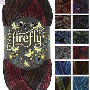 May include: A skein of King Cole Firefly Aran yarn featuring a black paper label with yellow dragonfly illustrations and the text King Cole firefly ARAN. The yarn displays a variegated color palette of deep red, black, and purple tones.