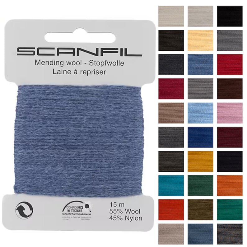 May include: A spool of blue mending wool labeled "SCANFIL." The label also includes the text "Mending wool - Stopfwolle Laine &agrave; repriser." The spool contains 15 meters of 55% wool and 45% nylon. A color chart is displayed to the right.