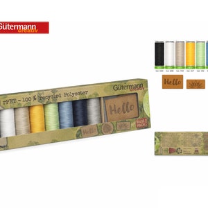 May include: A box of Gütermann rPET 100% recycled polyester thread in a value pack. The box contains 7 spools of thread in white, beige, yellow, green, blue, gray, and black. The box also includes a small wooden tag with the word "Hello" on it.