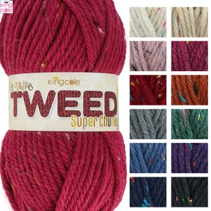 May include: A large ball of King Cole Big Value Tweed Super Chunky yarn in a rich red hue. The label displays the brand and yarn details. Various yarn colour samples are shown, including cream, pink, and blue, offering a range of options.