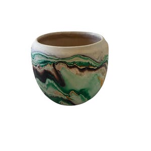 May include: A white ceramic mug with a black handle and the text "But First, Coffee" in a black, bold font. The mug is on a white surface. The mug is 4 inches tall.