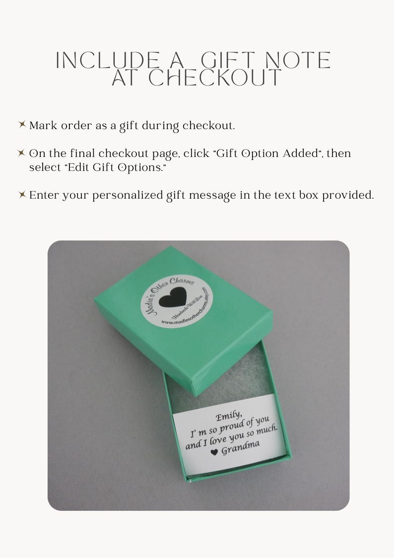 May include: A teal gift box with a white circular sticker featuring a black heart and the text Madie's Other Charms. Inside the box is a white card with the printed text: Emily, I'm so proud of you and I love you so much. Grandma.