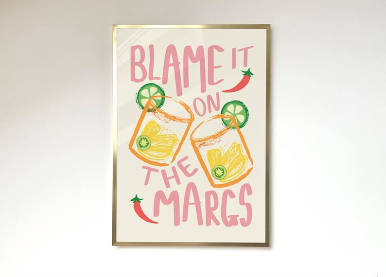 May include: A printable wall art design with a pink and white background featuring two glasses of margaritas with lime wedges and the text "Blame it on the Margs".