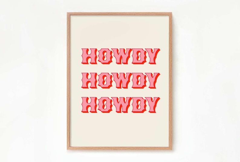 May include: A framed print with the word "HOWDY" repeated three times in a pink and red retro font on a cream background.