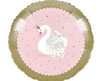 May include: Round foil balloon featuring a white swan with a gold crown and a tutu, floating on water. The swan is set against a pink background with gold stars, framed by a gold scalloped border. A festive party decoration.