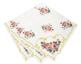 May include: A stack of white paper napkins with a gold border and a floral design featuring pink roses and green leaves.