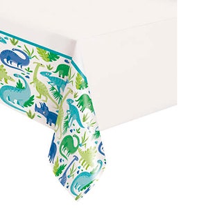 May include: A white plastic tablecloth with a blue border and a dinosaur pattern. The dinosaurs are green, blue, and brown and are surrounded by green leaves.