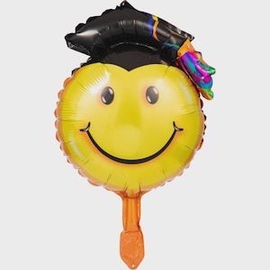 May include: A yellow smiley face balloon with a black graduation cap and a colorful tassel. The balloon has a long orange string.