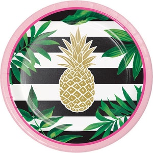 May include: Pink and black striped paper plate with a gold pineapple design and green palm leaves.