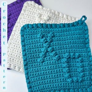 May include: Three crocheted pot holders in different colours: purple, white and teal. The teal pot holder has a textured design.