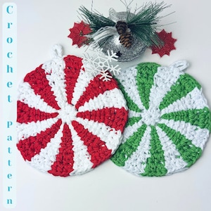 May include: Two crocheted peppermint candy ornaments, one red and white, the other green and white. The ornaments are on a white background.