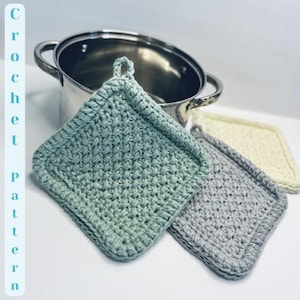 May include: Three crocheted pot holders in different colors: green, gray, and cream. The pot holders are square shaped and have a textured stitch pattern.