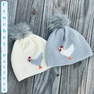 May include: Two crocheted hats featuring a chicken design. One hat is white with a grey chicken and the other is grey with a white chicken.
