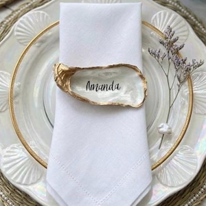 May include: A set of three ceramic mugs with a speckled, matte finish. The mugs are in shades of cream, light gray, and dark gray. Each mug has a simple, minimalist design, perfect for coffee or tea.