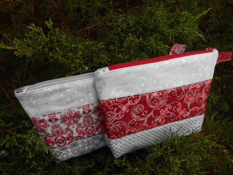 Pretty zipper pouches makes a nice gift for a lady Christmas colors of red or maroon with silver etching could use for evening pouch.