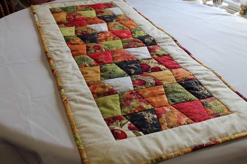 Tumbler table runner, the fall tumblers tremed in black makes a nice fall table topper, hand quilted. Fall harvest