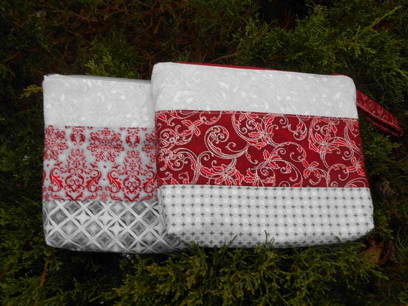 Pretty zipper pouches makes a nice gift for a lady Christmas colors of red or maroon with silver etching could use for evening pouch.