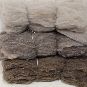 Wool- Natural colors in taupe, and white, carded wool in bundles of 4 1-ounce batts for felting and other fiber arts.